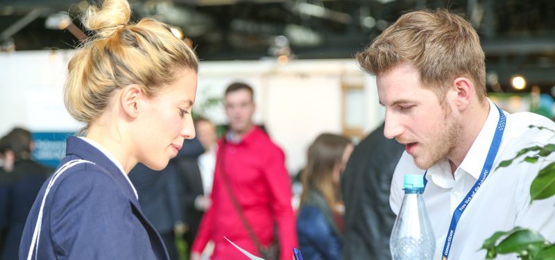 Besucherin im Gespräch mit einem Standbetreuer